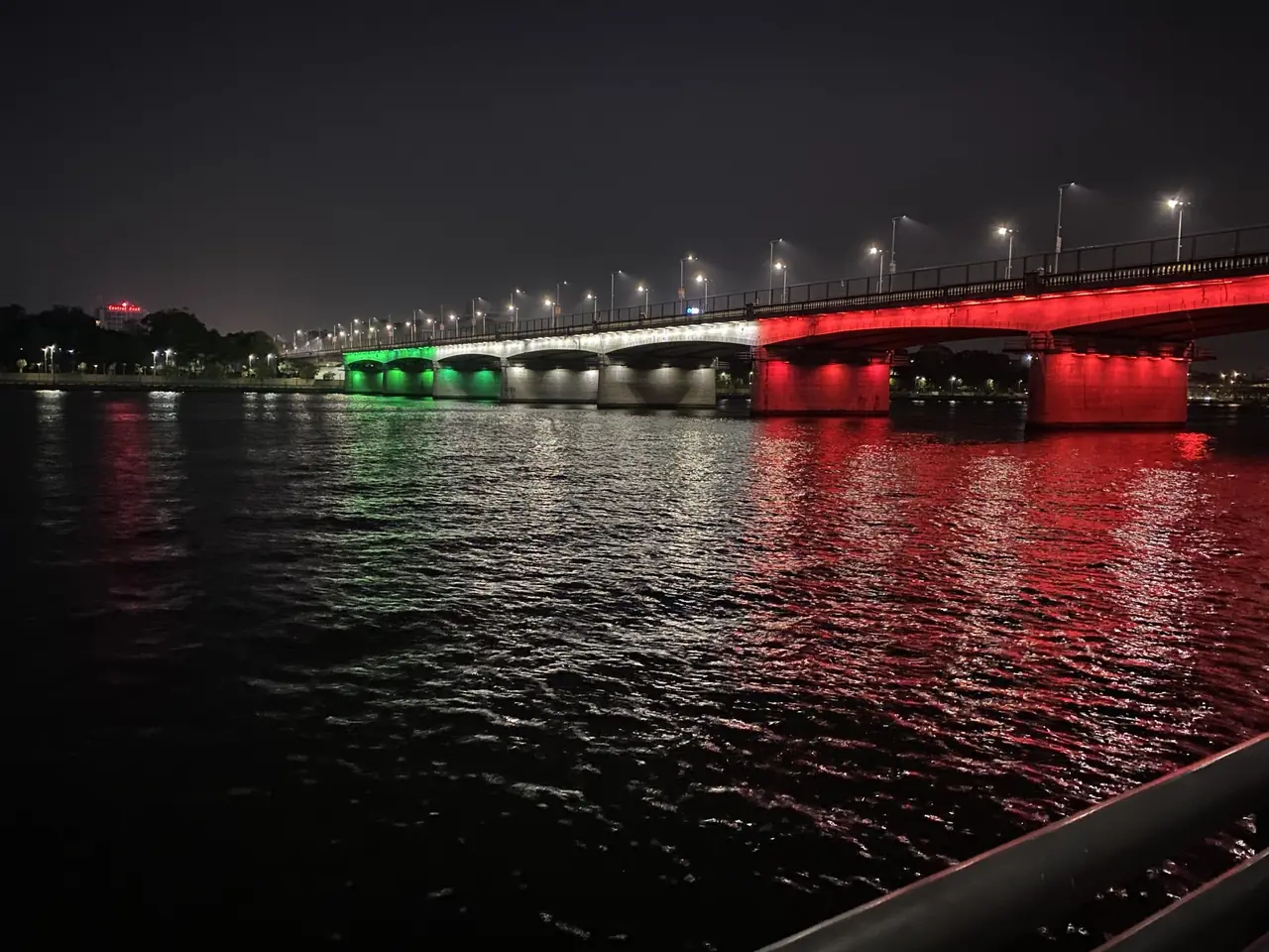 A bridge over the Sabarmati in Ahmedabad lit in red, white and green at night